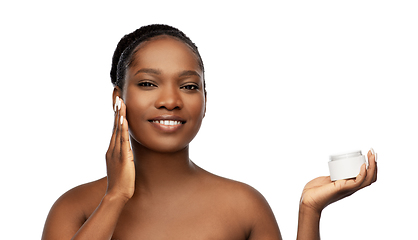 Image showing smiling african american woman with moisturizer