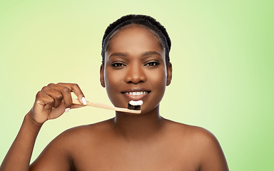 Image showing african woman cleaning teeth with toothbrush