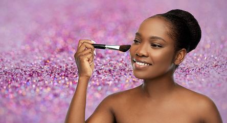 Image showing woman with make up brush applying blush to face