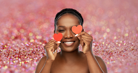 Image showing smiling african american woman with red hearts