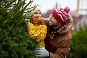 Image showing happy family choosing christmas tree at market