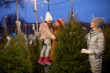 Image showing happy family choosing christmas tree at market