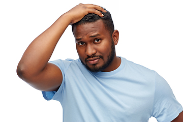 Image showing unhappy young african american man touching hair