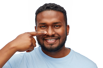 Image showing african american man pointing finger to his nose