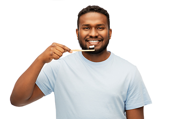 Image showing smiling african man with toothbrush cleaning teeth