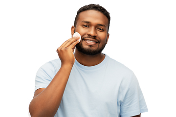 Image showing african american man cleaning face with cotton pad