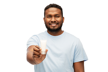 Image showing happy african american man showing moisturizer