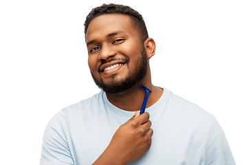 Image showing smiling african man shaving beard with razor blade