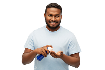 Image showing happy african man applying shaving foam to hand