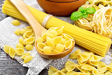 Image showing Pasta different with basil on black board