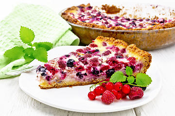 Image showing Pie with raspberries and currants in plate on board