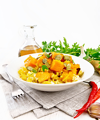 Image showing Porridge millet with spicy pumpkin in plate on wooden board