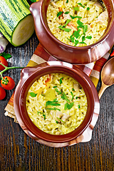 Image showing Rice with chicken and vegetables in two pots on board top