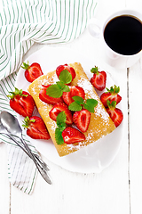 Image showing Roll with cream and strawberries in plate on board top