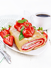 Image showing Roll with cream and strawberries in plate on light board
