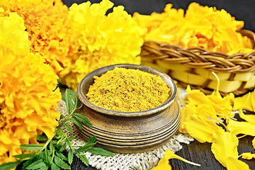 Image showing Saffron imerta in bowl with petals on black board