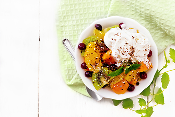 Image showing Salad fruit with cranberries in bowl on board top