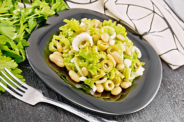 Image showing Salad of beans and olives in plate on black board