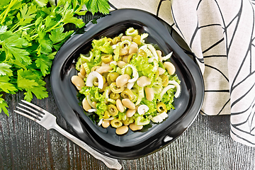 Image showing Salad of beans and olives in plate on board top