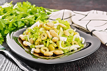 Image showing Salad of beans and olives in plate on board