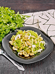 Image showing Salad of beans and olives in plate on towel