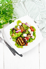 Image showing Salad of eggplant with cheese and tomatoes on white board top