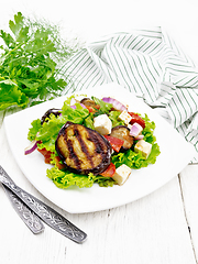 Image showing Salad of eggplant with cheese and tomatoes on wooden table