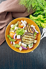 Image showing Salad of eggplant with feta and tomatoes on black board top