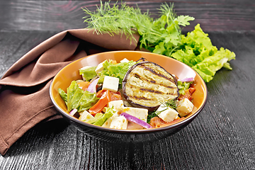 Image showing Salad of eggplant with feta and tomatoes on dark board