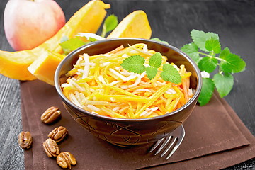 Image showing Salad of pumpkin and apple in bowl on black board