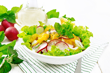 Image showing Salad of radish and orange with mint on board