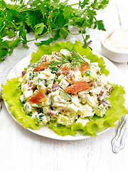 Image showing Salad of salmon and avocado with mayonnaise on light board