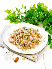 Image showing Salad of salmon and rice in plate on light wooden board