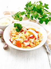 Image showing Salad of surimi and tomatoes with eggs on table