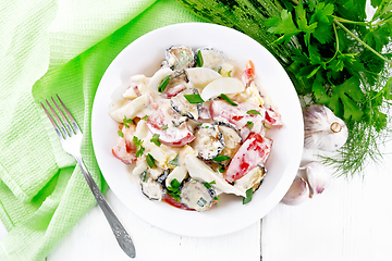 Image showing Salad with fried zucchini in plate on board top