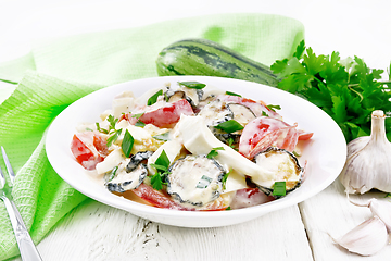 Image showing Salad with fried zucchini in plate on board