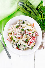 Image showing Salad with fried zucchini in plate on light board top