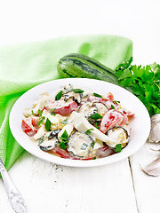 Image showing Salad with fried zucchini in plate on wooden table