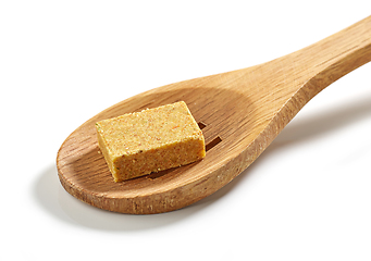 Image showing instant chicken broth cube in wooden spoon