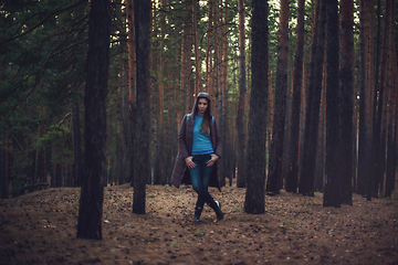 Image showing Woman in the autumn dark forest