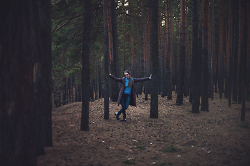 Image showing Woman in the autumn dark forest