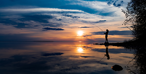 Image showing Woman fishing on Fishing rod spinning in Finland