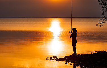 Image showing Woman fishing on Fishing rod spinning in Finland