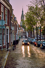 Image showing Delft cobblestone street with car in the rain