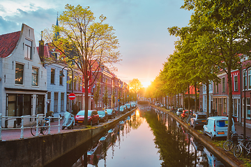 Image showing Delt canal with old houses and cars parked along on sunset