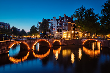 Image showing Amterdam canal, bridge and medieval houses in the evening