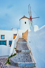 Image showing Old greek windmill on Santorini island in Oia town with stairs in street. Santorini, Greece