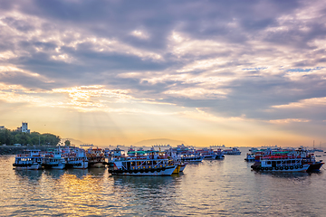 Image showing Tourist boats in sea on sunrise in Mumbai, India