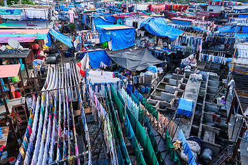 Image showing Dhobi Ghat is an open air laundromat lavoir in Mumbai, India with laundry drying on ropes