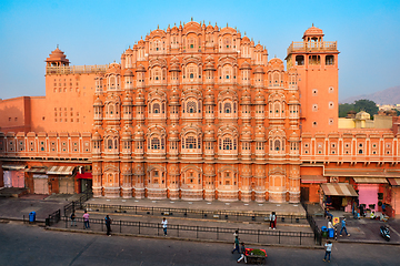 Image showing Famous historical landmak pink Hawa Mahal Palace of Winds with people and transport. Jaipur, Rajasthan, India